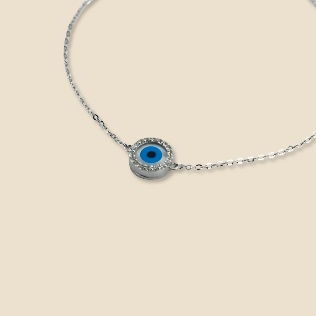 Close-up of 14K White Gold Evil Eye Bracelet on a plain background, highlighting the sleek white gold chain and detailed evil eye charm.