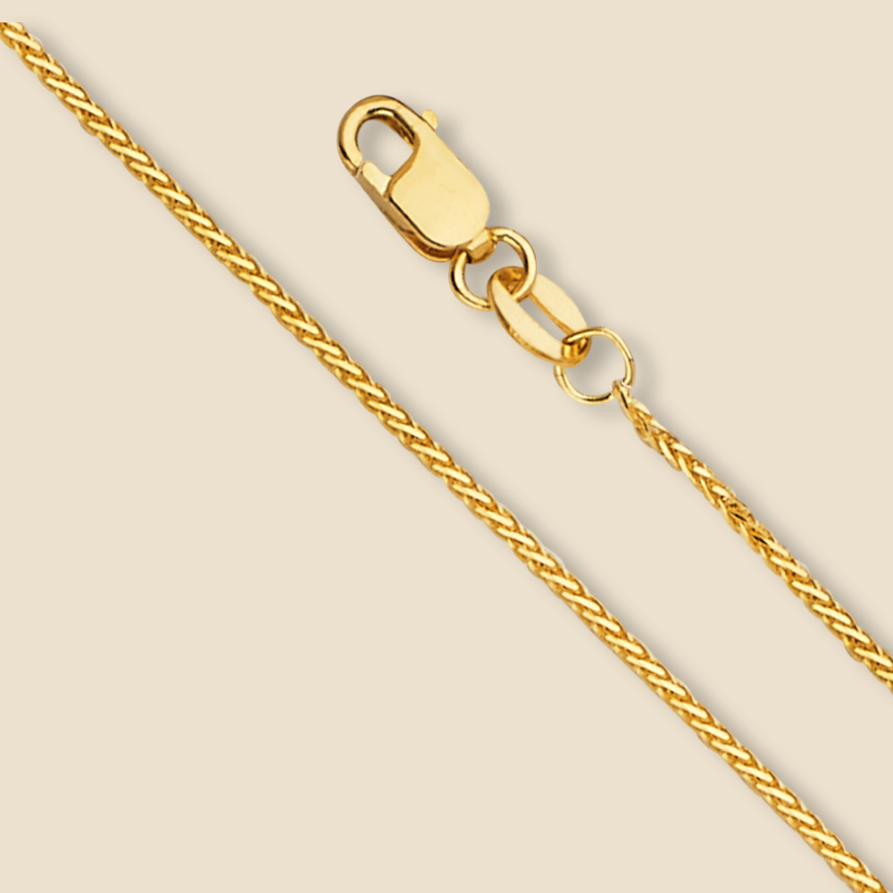 14K yellow gold 1mm round wheat chain necklace displayed on a plain background. Features a polished finish and diamond-cut detailing for a subtle sparkle.