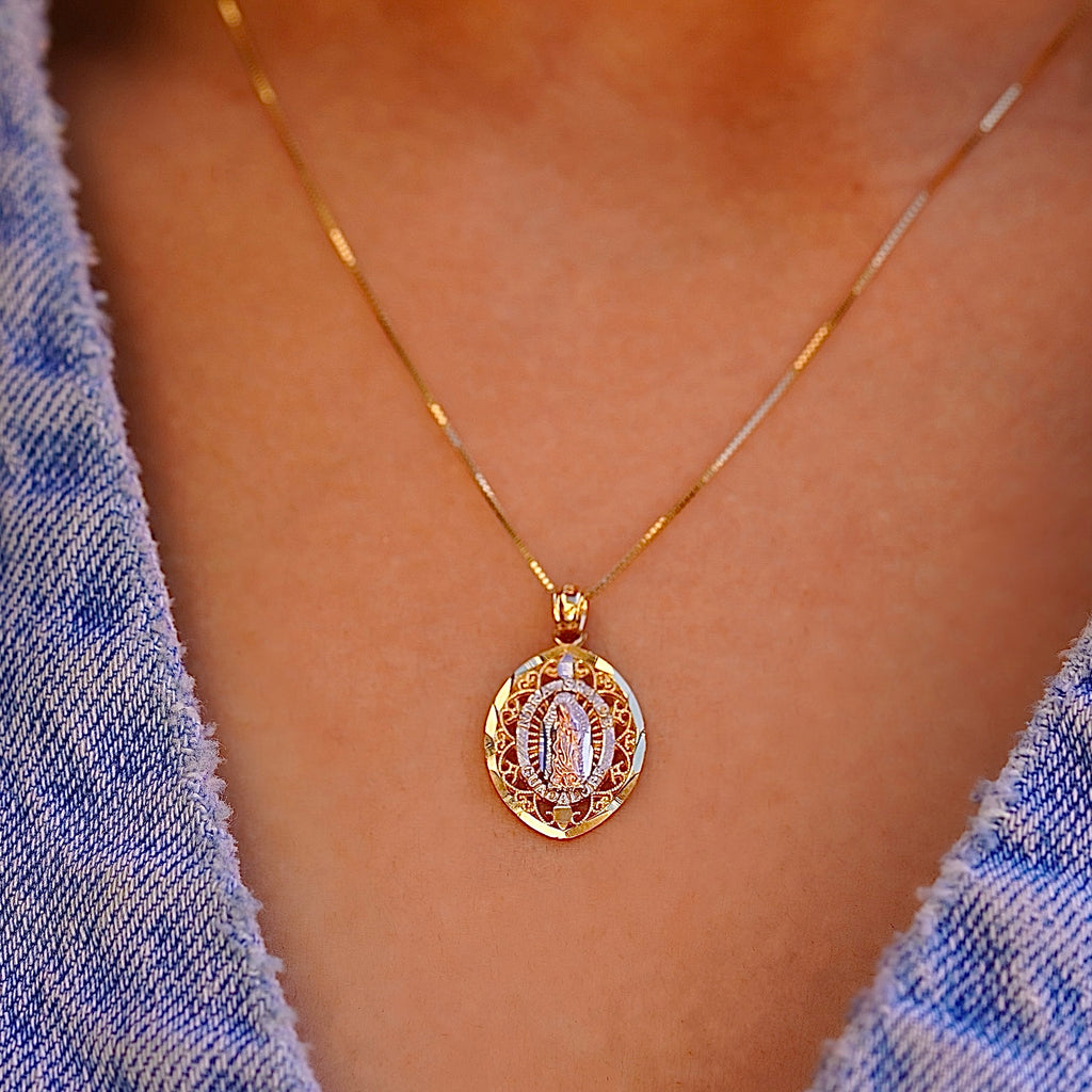 A stunning 14K Tri-Color Gold Our Lady of Guadalupe Pendant worn by a model, showcasing its elegant size and spiritual significance as a statement piece of fine religious jewelry.