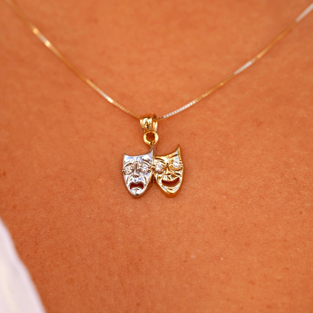 Model wearing 14K Two-Tone Solid Gold Comedy & Tragedy Charm from the right angle, highlighting cubic zirconia accents and two-tone gold design.