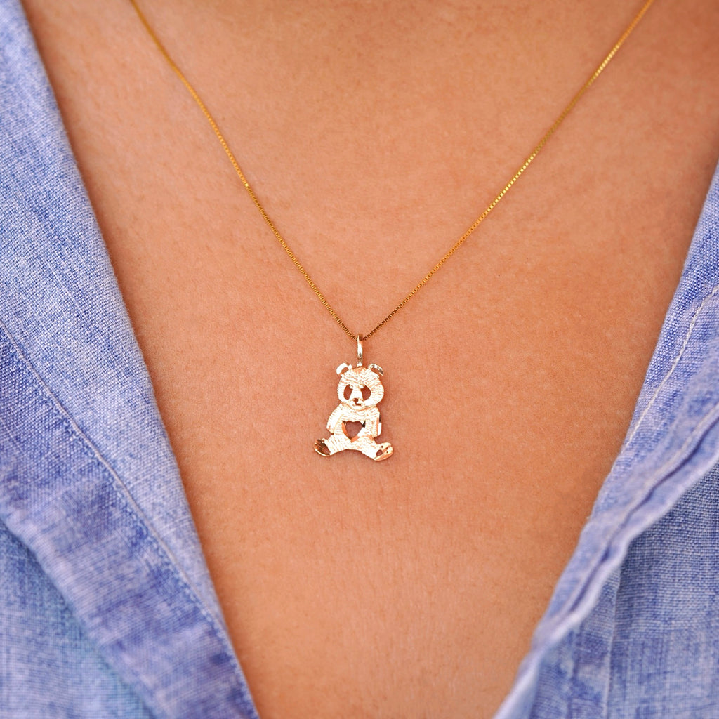 Model wearing a delicate 14K gold panda charm pendant on a chain, highlighting how the dainty design sits elegantly on the neckline, perfect for everyday wear or as a thoughtful gift.