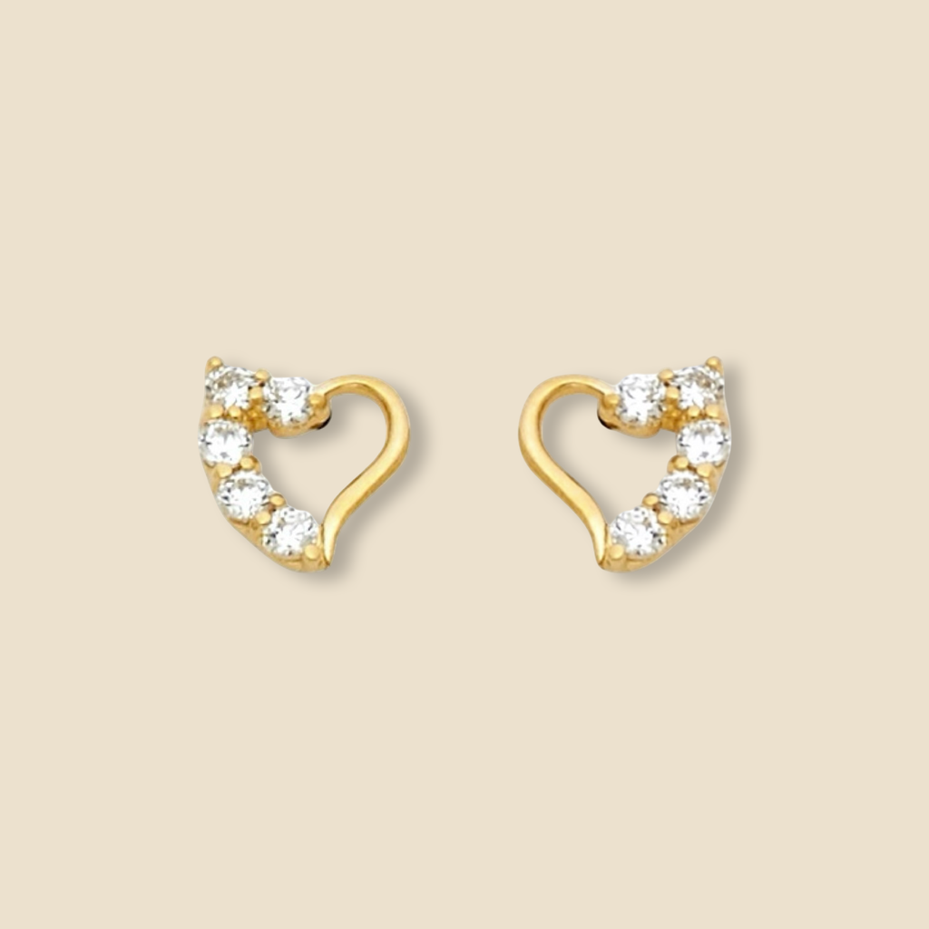 Close-up of 14K Yellow Gold Heart Pendant with White CZ stone on a plain background, highlighting fine craftsmanship.