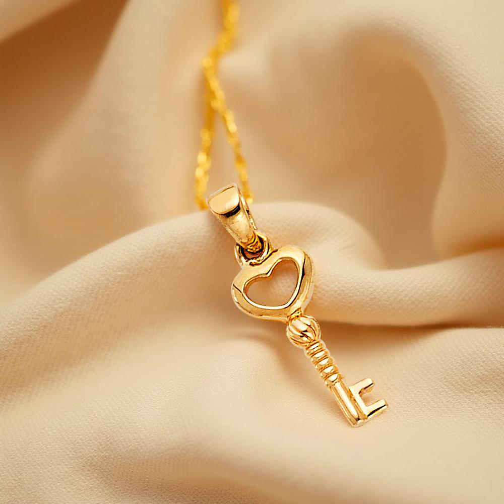 Minimalist 14K Gold key charm pendant resting on soft, textured off-white linen cloth, highlighting its small size and delicate design.