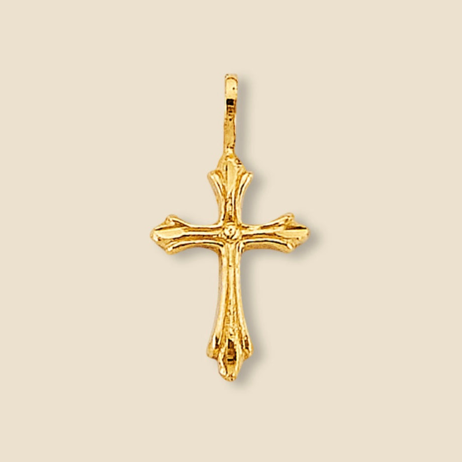 Close-up of a 14K yellow gold cross pendant on a plain background, emphasizing its delicate size and high-polish shine.