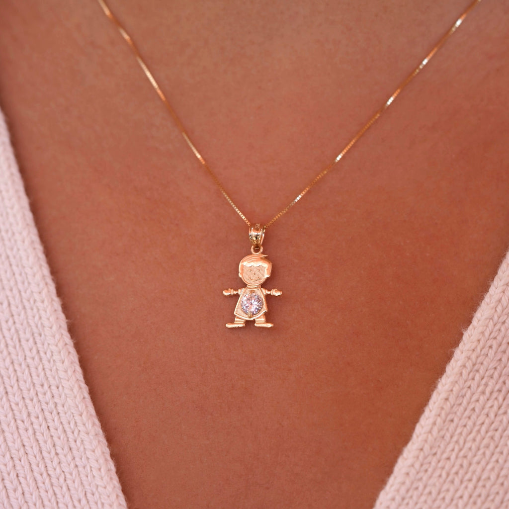 A model wearing the April boy charm on a delicate gold chain, showcasing how the dainty 14K gold pendant sits beautifully near the collarbone, with the white birthstone catching light elegantly.