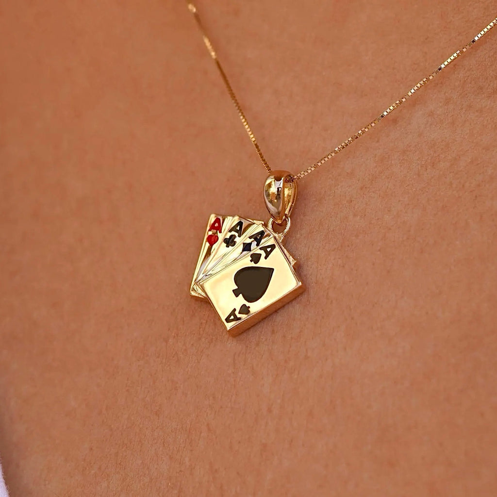 A model wearing the 14K Solid Gold 4 of a Kind Aces Charm on a fine gold chain, showcasing the pendant's elegant and playful design as it adds a touch of luck and style to her outfit. The charm is visible against a casual, everyday setting.