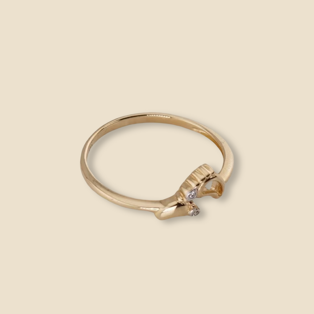 14K Solid Gold Baby Feet Ring displayed on a plain background, highlighting its polished finish and delicate design.