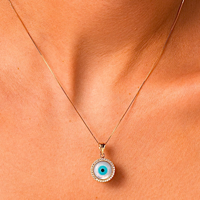 A model showcases the 14K Gold Evil Eye Charm with the vibrant blue eye, elegantly paired with a delicate gold chain for a stylish and protective everyday look.