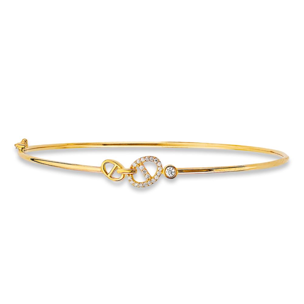 Lightweight flexible gold bangle photographed on a smooth white background, highlighting its gentle shimmer.