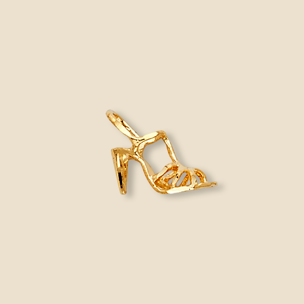 Minimalist product shot of a 14K yellow gold high heel pendant against a plain background, highlighting the smooth lines, tiny structure, and high polish of the fashion-inspired charm.