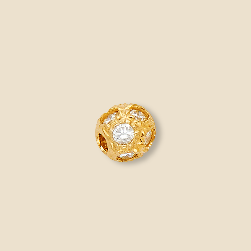 Elegant 6mm 14K yellow gold bead charm pendant with a diamond-cut finish and sparkling cubic zirconia stones, displayed on a plain background to highlight its radiant shine and fine craftsmanship.