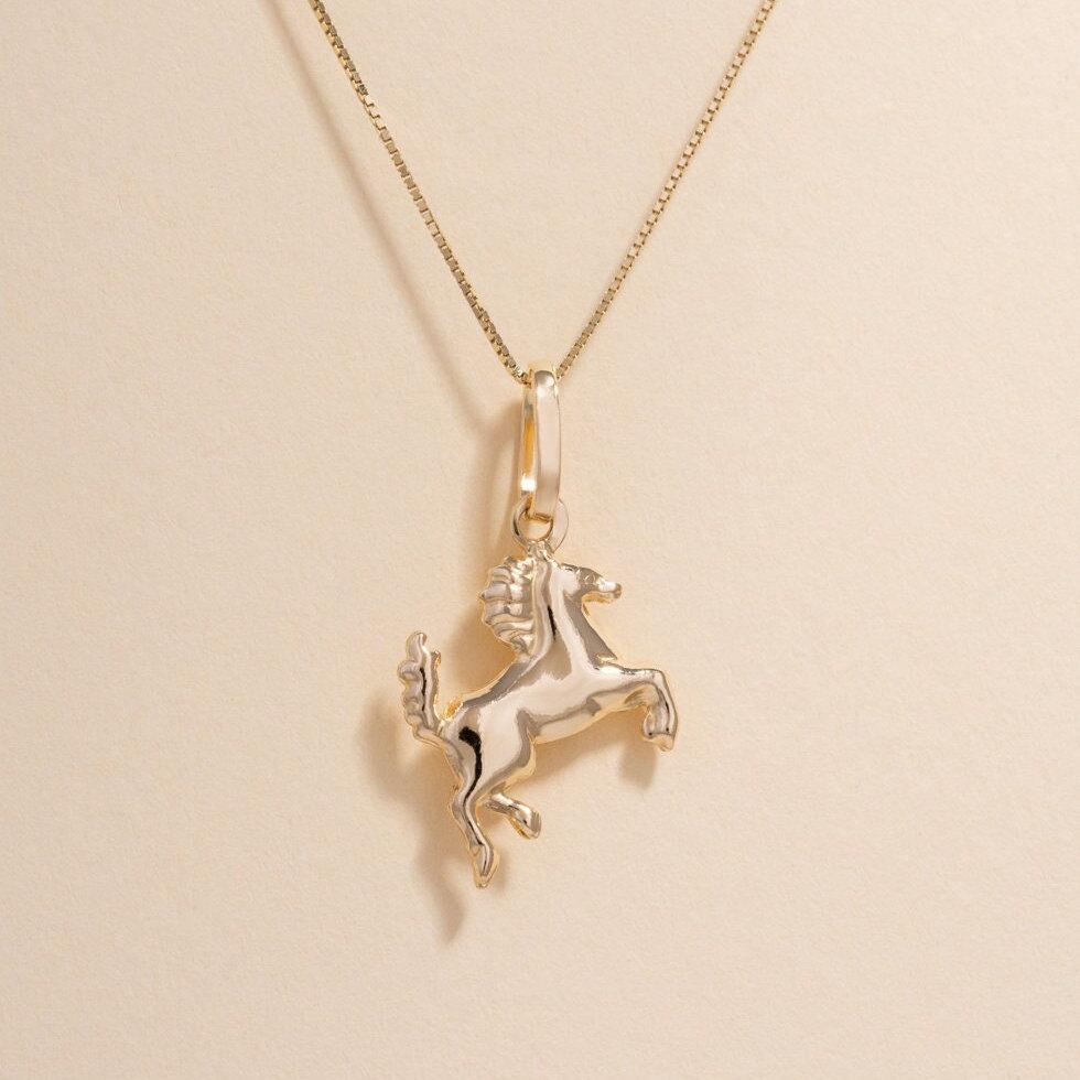 14K Gold Horse Charm on a plain background, showcasing its detailed craftsmanship and polished finish.