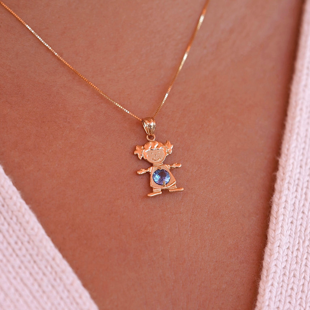 A model wearing 14K solid gold girl charm pendant with March light blue birthstone on a necklace chain.