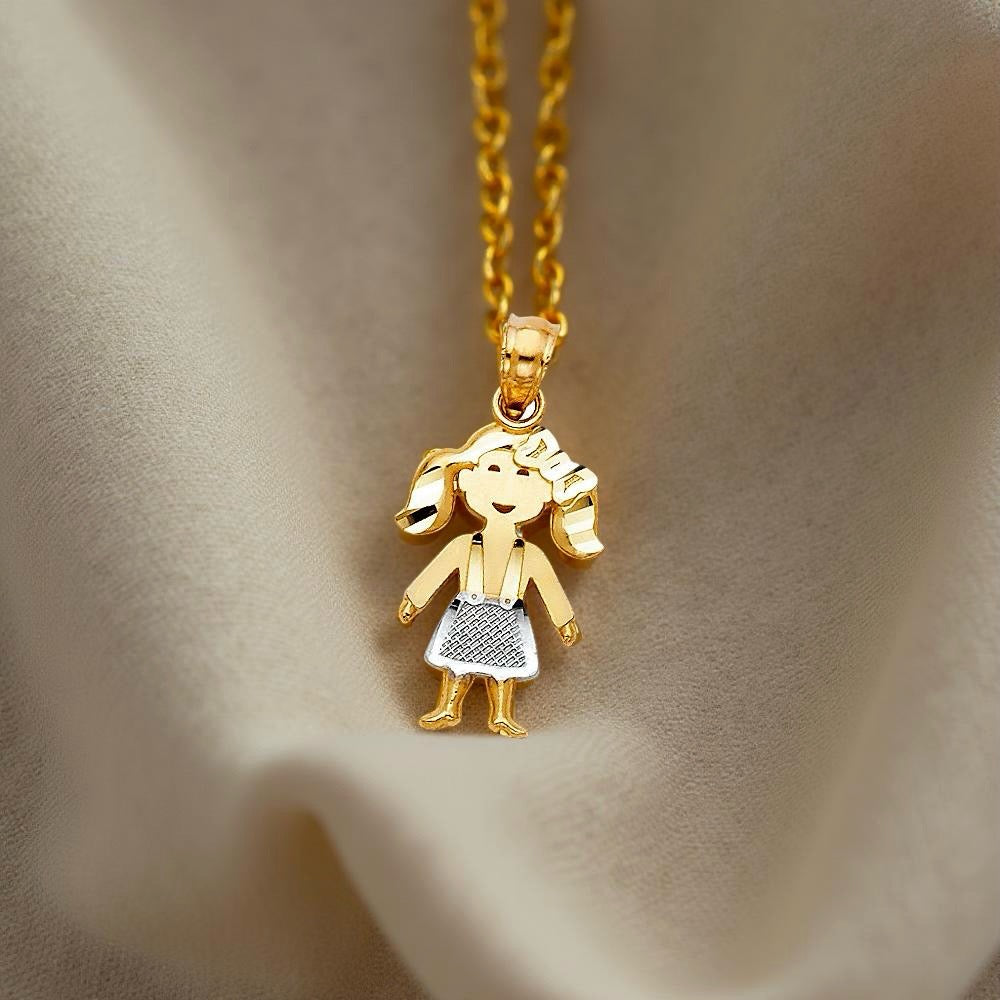 Close-up of a 14K two-tone gold baby girl pendant resting gently on textured off-beige cloth. The warm, soft fabric highlights the pendant's graceful details and radiant gold tones, evoking a sense of love and warmth.