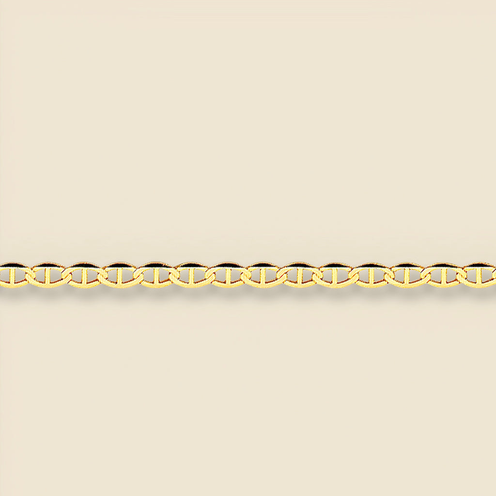 Close-up of 14K gold mariner chain necklace on a plain background, clearly showing the structure, length, and smooth polish of the solid gold links.