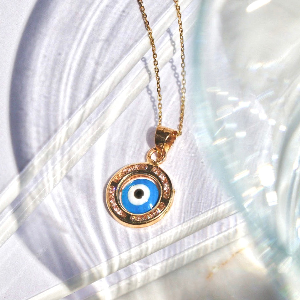 14K Yellow Gold Evil Eye Charm Pendant displayed against a plain background, showcasing its intricate detailing and polished finish.