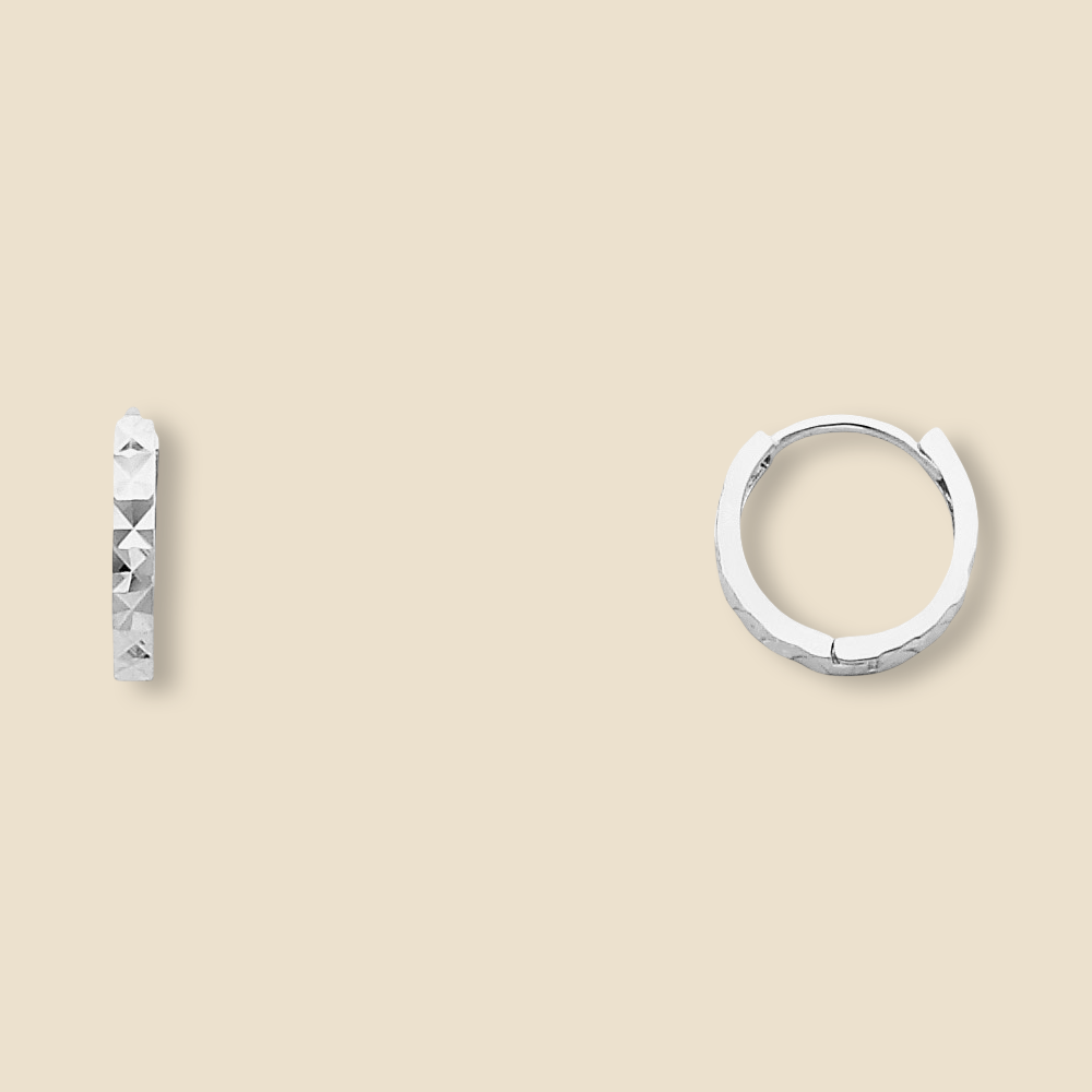 A pair of 14K white Gold Huggies earrings against a plain backdrop, clearly showing the 11mm round shape and diamond-cut design.