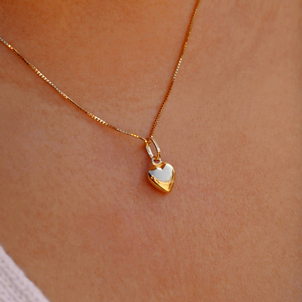 Dainty 14K Gold Hollow Heart Pendant worn by a model, gracefully resting on the collarbone, adding a touch of elegance to any outfit.