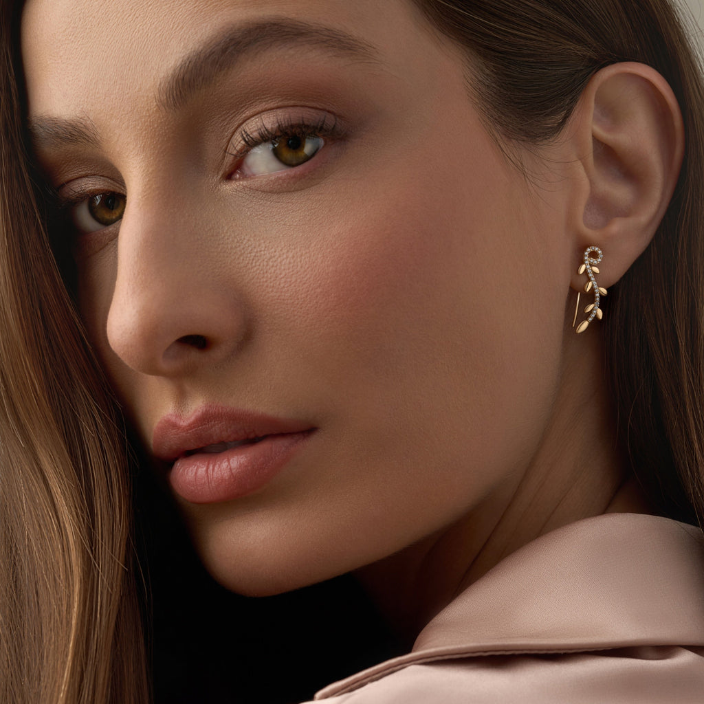 Model wearing 14K Yellow Gold Fancy CZ Drop Earrings, capturing their graceful drop design and subtle sparkle.