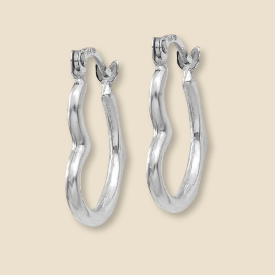 Close-up of minimalist 14K white gold heart-shaped hoop earrings, showcasing their polished finish and delicate design, set against a plain white background.