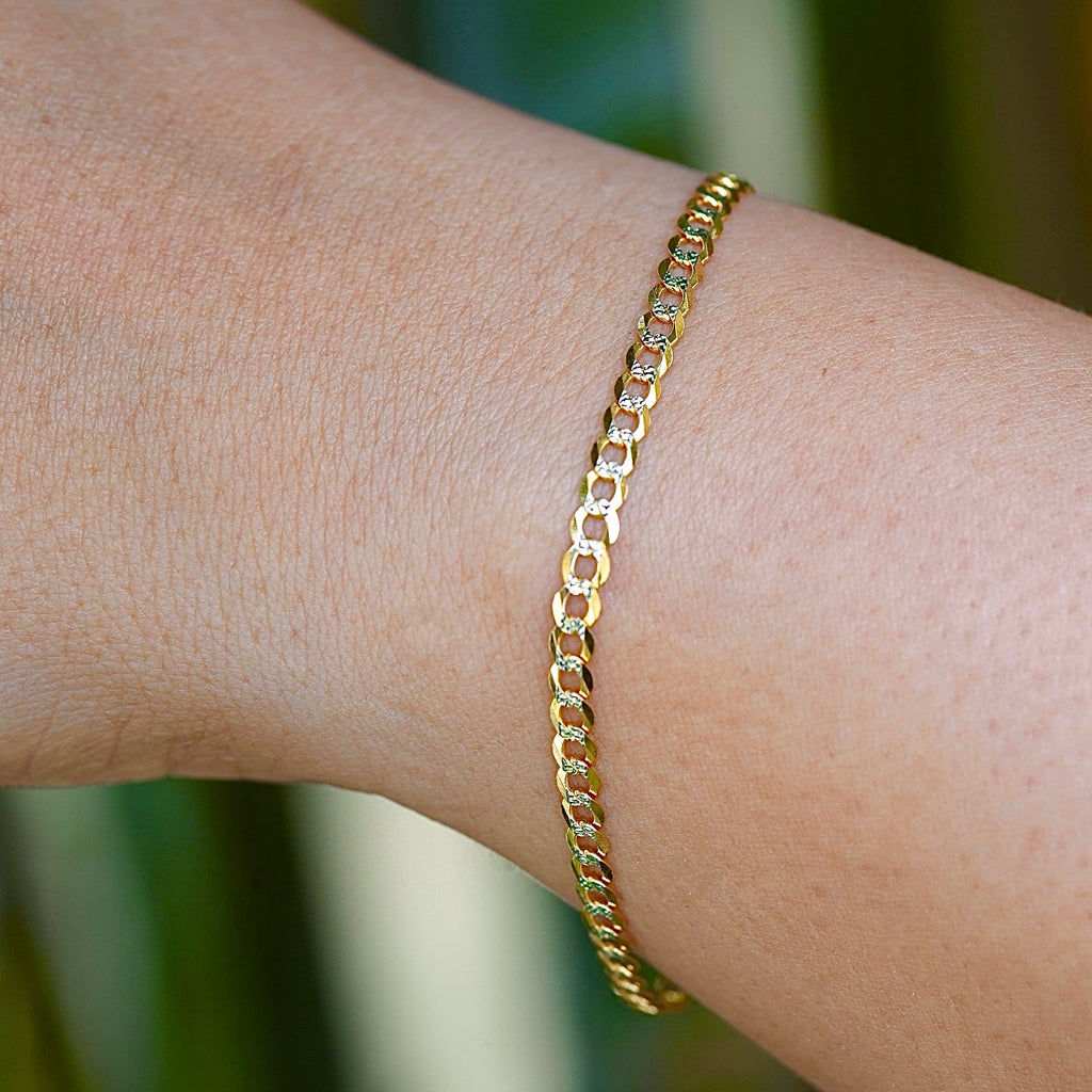 A model wearing the 3.2mm 14K Gold Cuban Link Bracelet with a white pave design, showcasing its elegant shine.