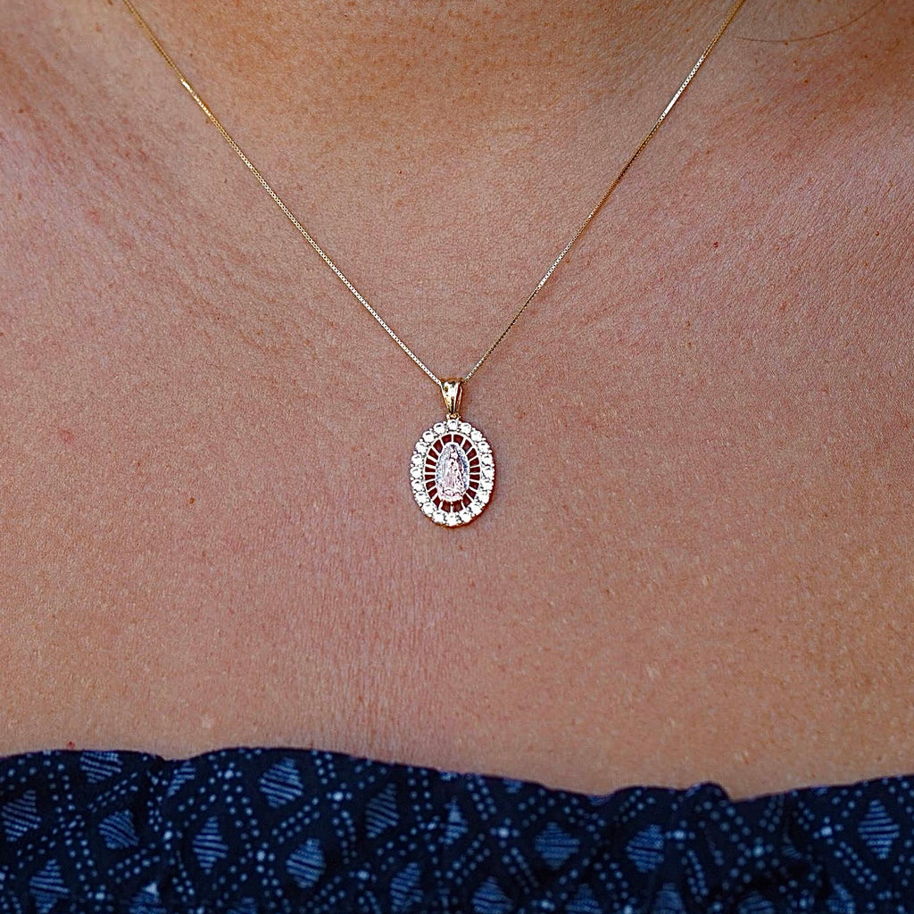14K Gold Lady of Guadalupe Charm worn by a model, elegantly displayed on a delicate chain. The radiant gold finish and cubic zirconia accents shine beautifully, making it a perfect religious jewelry piece for everyday wear or special occasions.