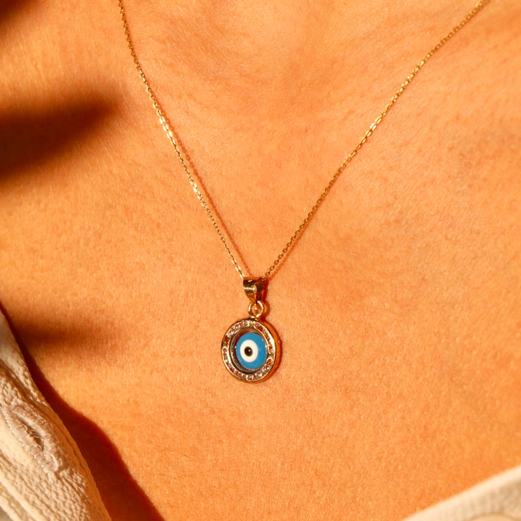 A model wearing the 14K Yellow Gold Evil Eye Charm Pendant, highlighting its elegant design and symbolic significance.