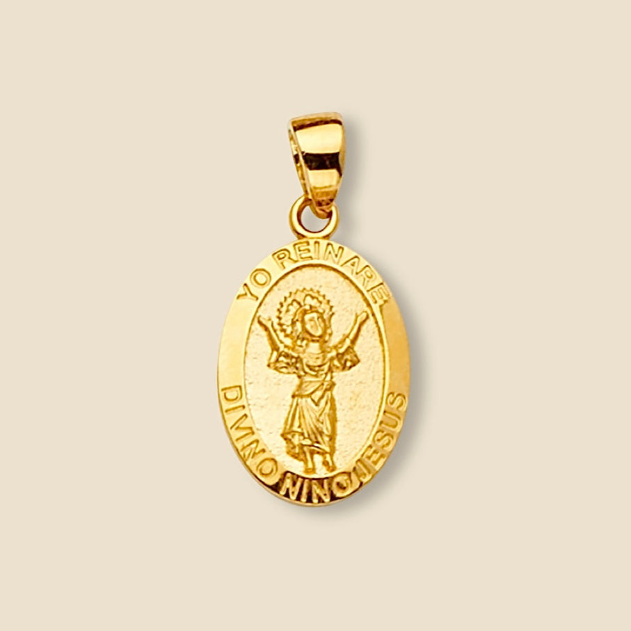 Polished 14K gold Baby Jesus pendant isolated on a plain background, showing its slim profile and devotional design.