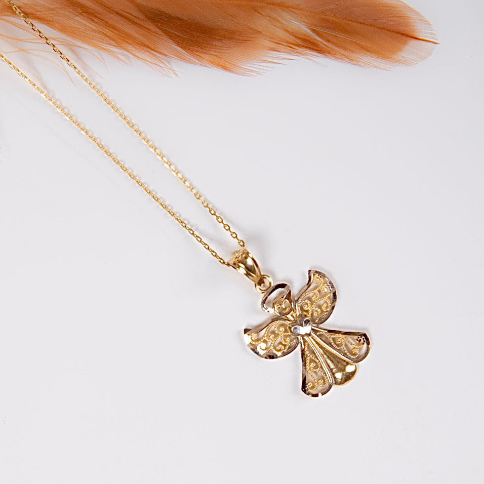 A close-up of the 14K Gold Two-Tone Angel Charm on a white backdrop, showcasing its intricate detailing and polished yellow and white gold finish.
