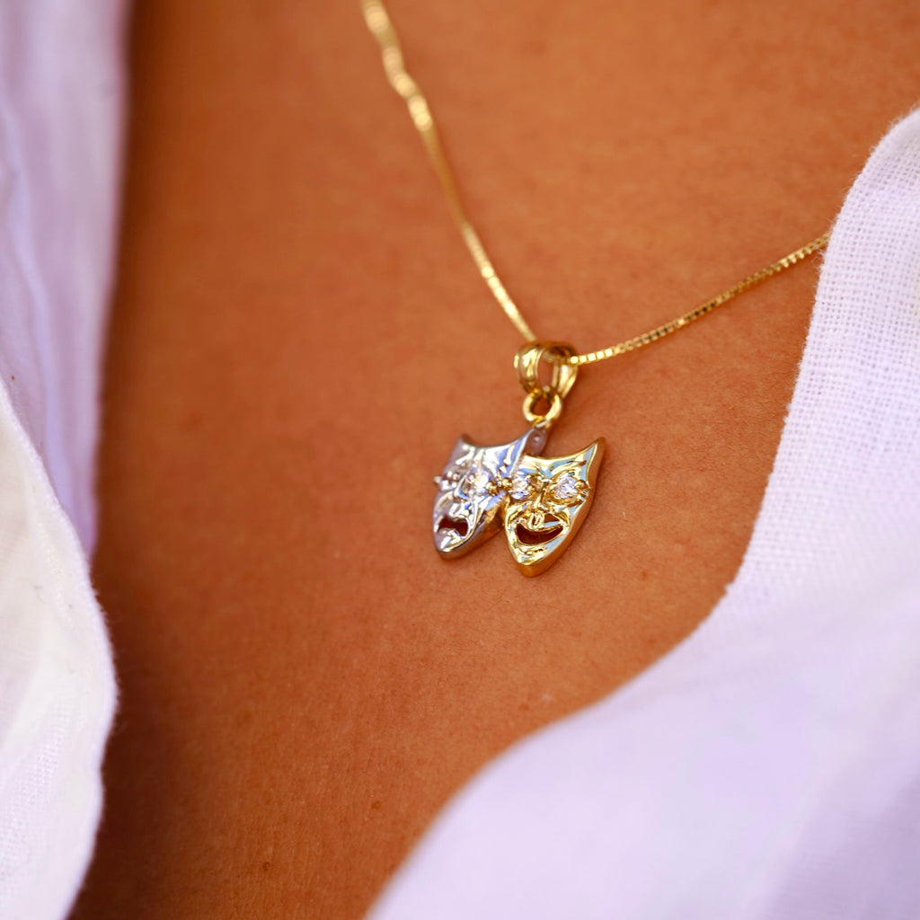 Model wearing 14K Two-Tone Solid Gold Comedy & Tragedy Charm from the right angle, highlighting cubic zirconia accents and two-tone gold design.