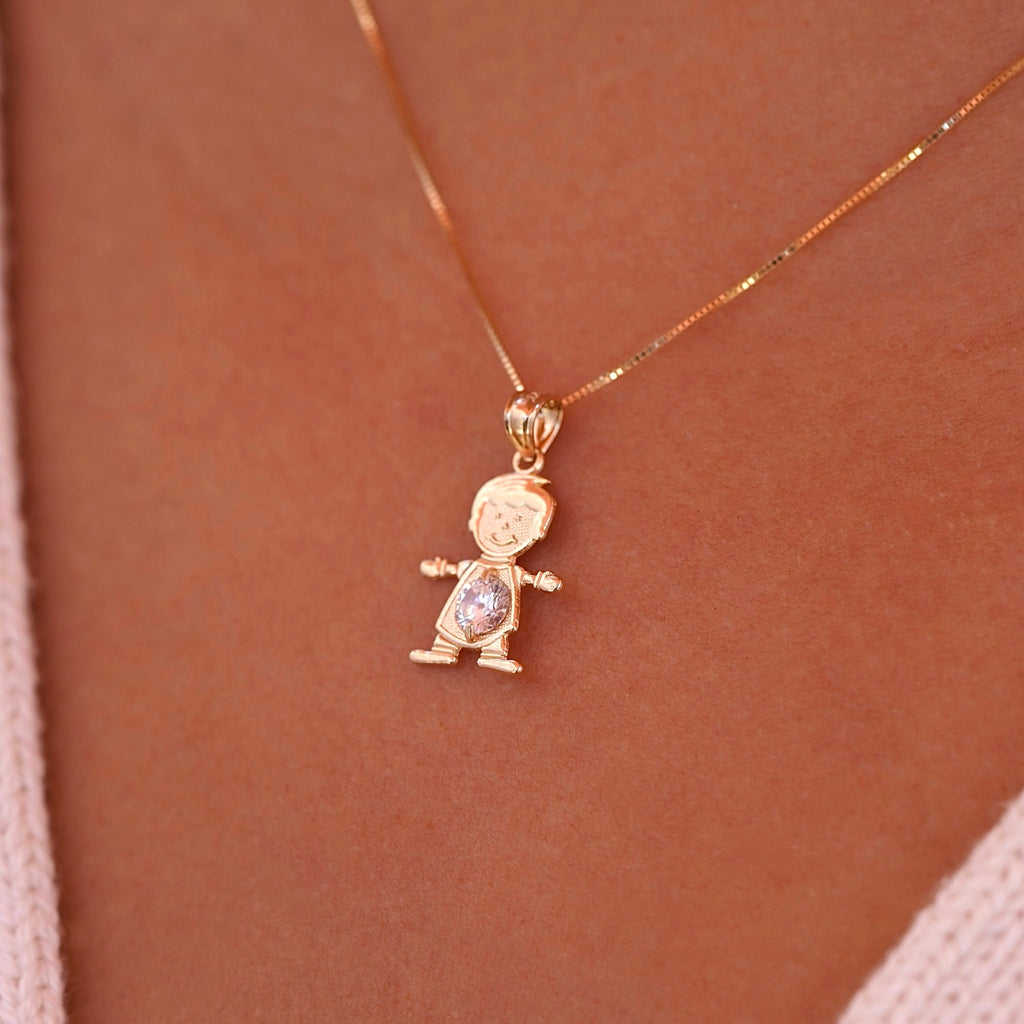 A model wearing the April boy charm on a delicate gold chain, showcasing how the dainty 14K gold pendant sits beautifully near the collarbone, with the white birthstone catching light elegantly.