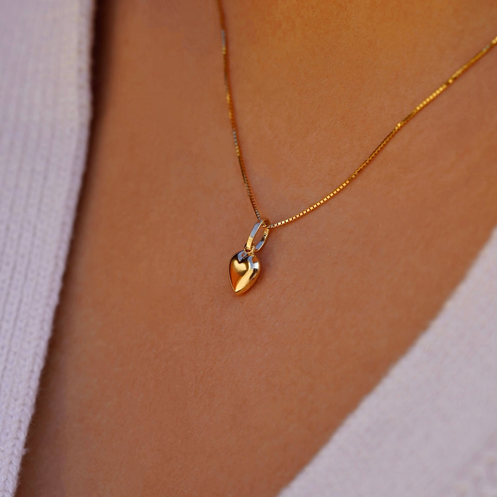 Dainty 14K Gold Hollow Heart Pendant worn by a model, gracefully resting on the collarbone, adding a touch of elegance to any outfit.