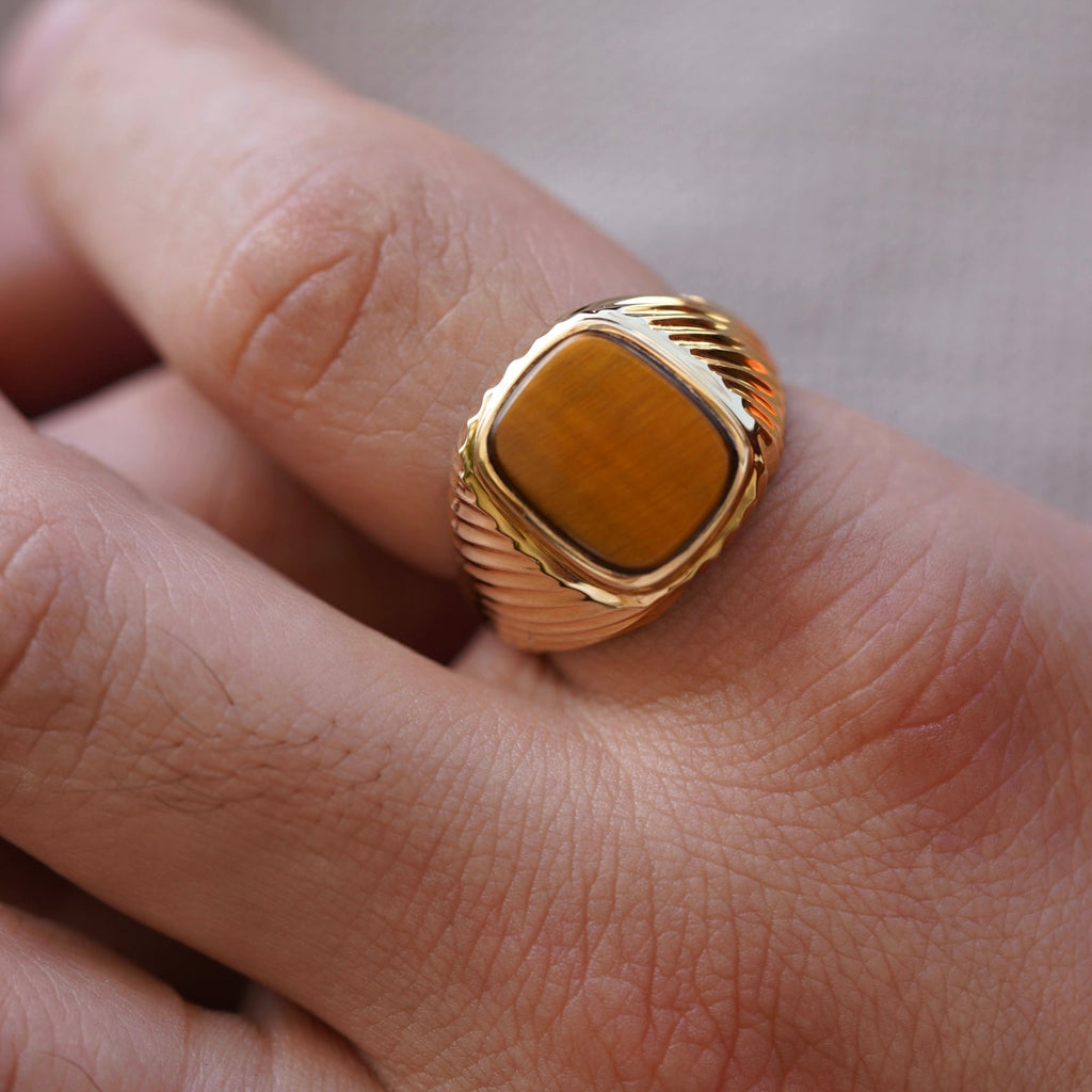 A sophisticated men's 14K gold ring with a 18mm width, worn on a model's hand. The polished yellow gold reflects light, adding elegance and confidence to any look.