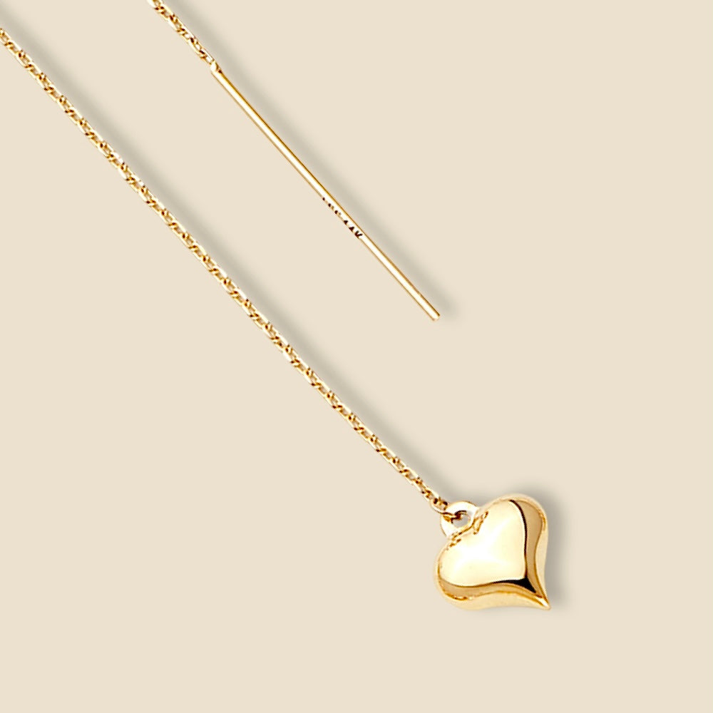 A pair of 14K yellow gold double-line heart earrings resting on plain background, highlighting the elegant 65mm drop length and minimalist open-heart silhouette with a polished, high-shine finish.