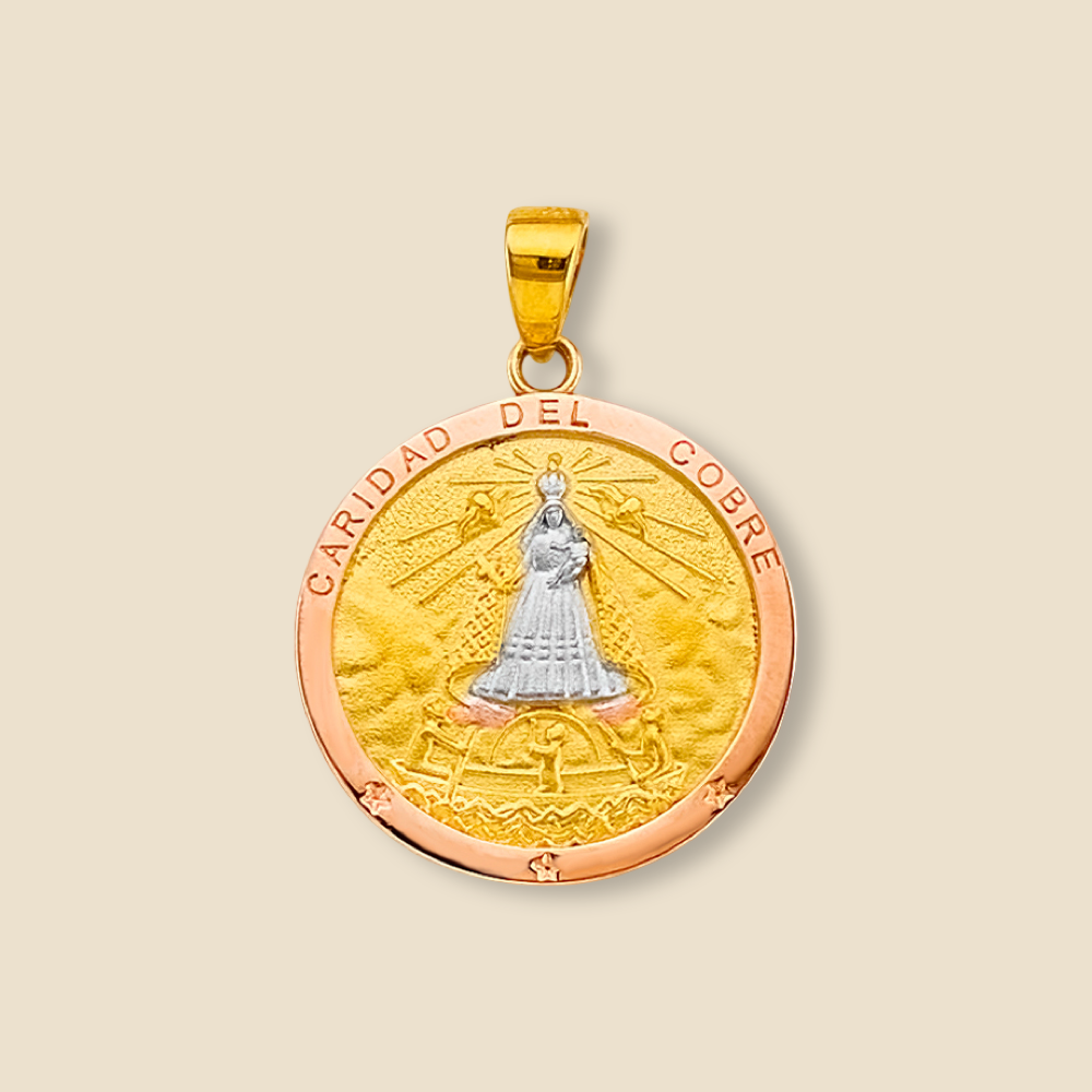 Detailed image of a 14K tri-color Caridad del Cobre medal pendant displayed on a plain background, clearly showing the Virgin Mary design and radiant metal tones.