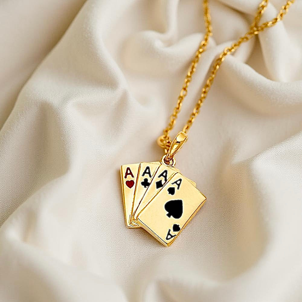 14K two-tone gold Ace poker card pendant displayed on soft off-white fabric, highlighting its textured design.