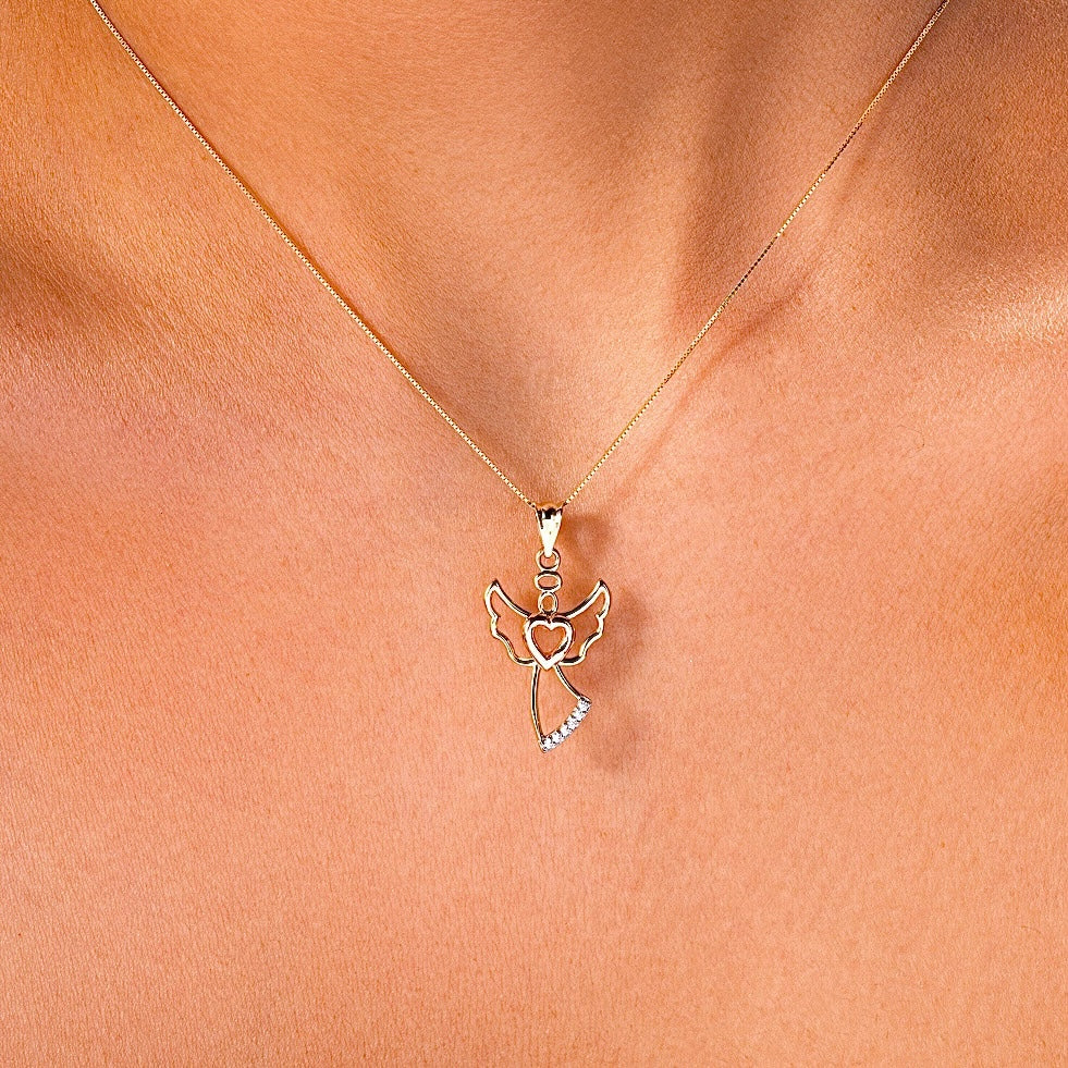 A model elegantly wearing a 14K gold angel pendant on a fine chain, showcasing its dainty and meaningful presence as a graceful accessory for everyday wear.