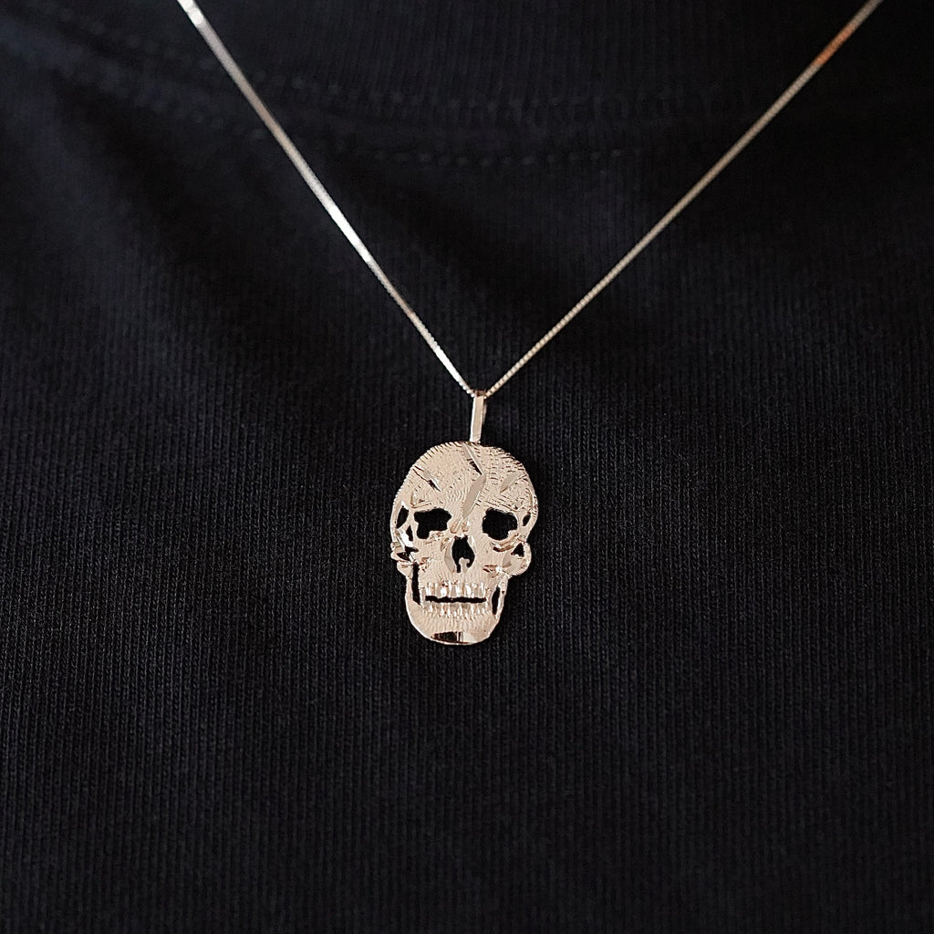 Model wearing a 14K Solid Gold Skull Charm on a gold chain, showcasing its bold and stylish appeal.