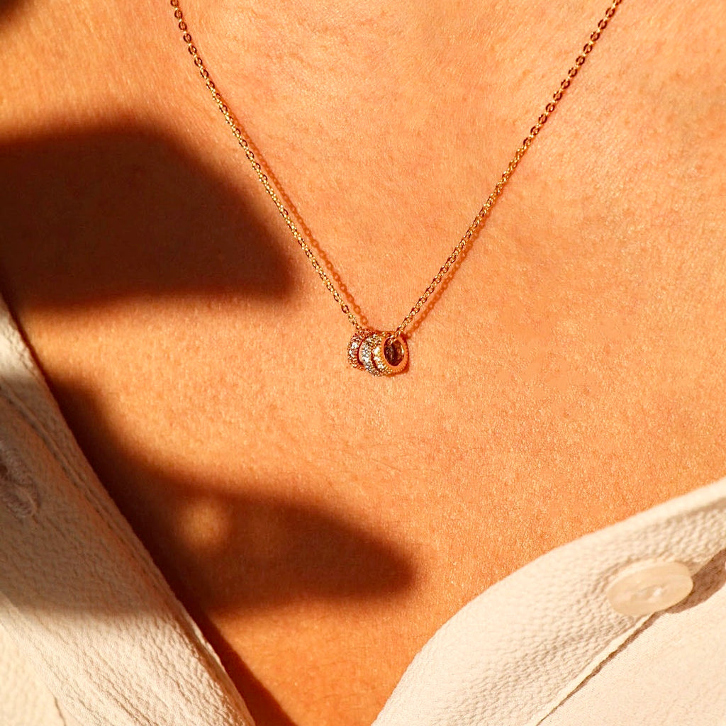 Model wearing the 14K Solid Gold Circles Necklace, showcasing its delicate design and perfect for layering.