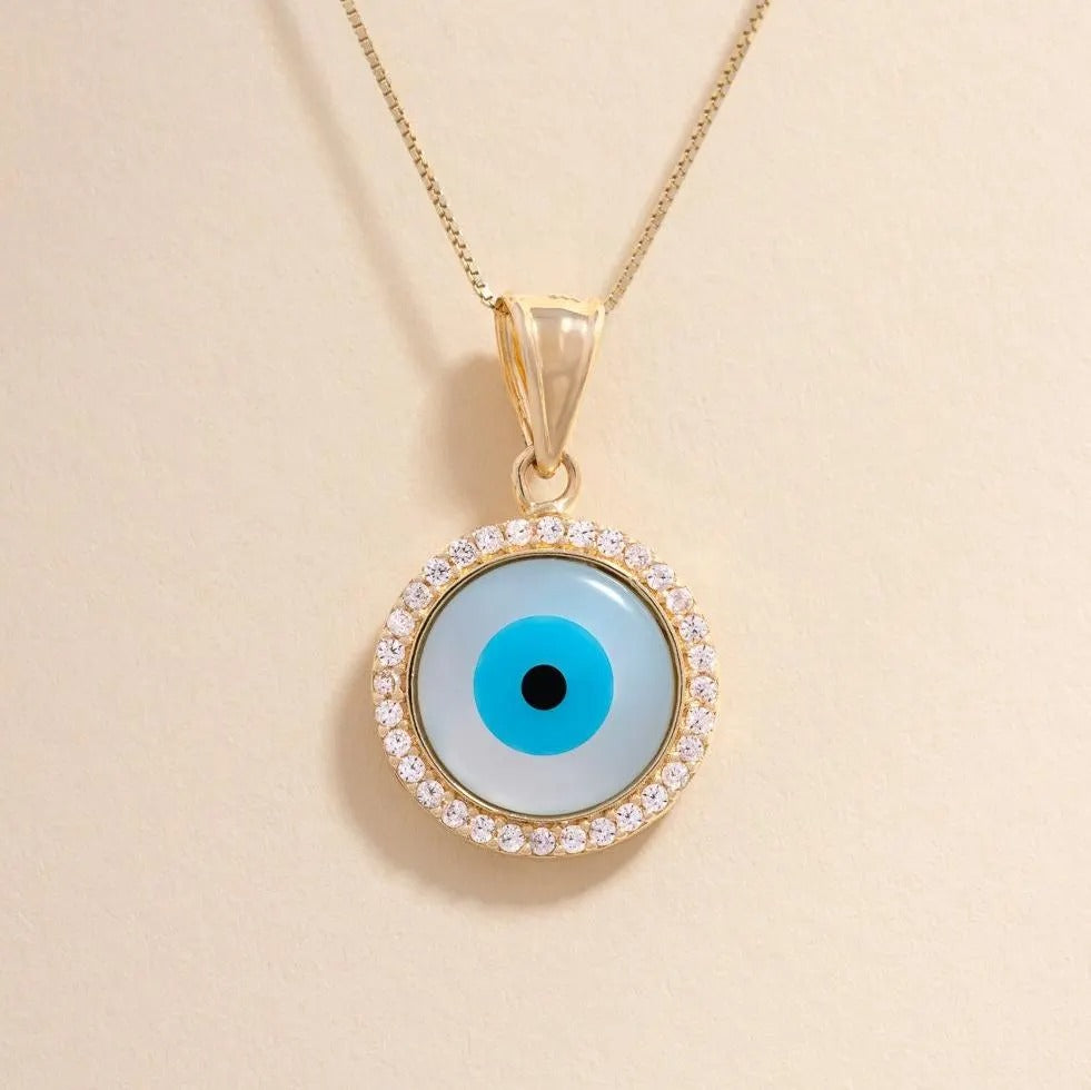 14K Gold Evil Eye Charm Pendant displayed against a plain background, highlighting its polished finish, sparkling cubic zirconia centerpiece, and intricate evil eye design.