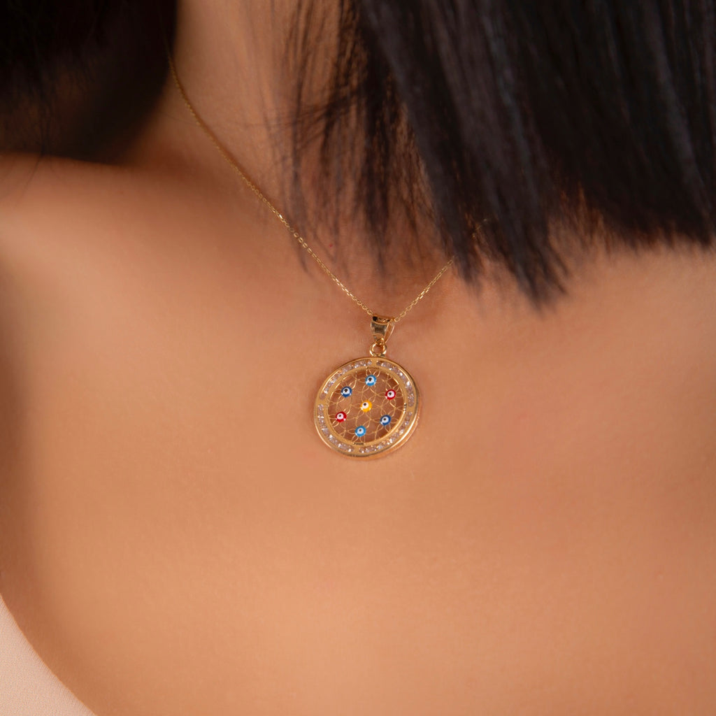 Model wearing the 14K Solid Gold Evil Eye Pendant on a delicate gold chain, showcasing its elegant shine and minimalist design against the skin.