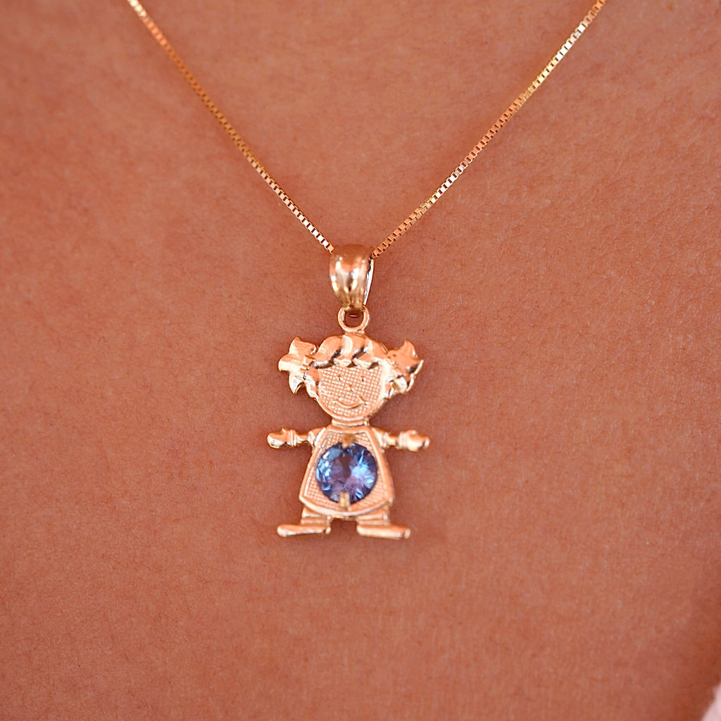 A model wearing 14K solid gold girl charm pendant with March light blue birthstone on a necklace chain.