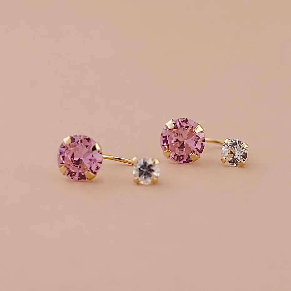 14K Solid Gold Telephonic Earrings with pink and white zirconia stones, resting on a plain background to highlight their polished finish and secure screw-back design.
