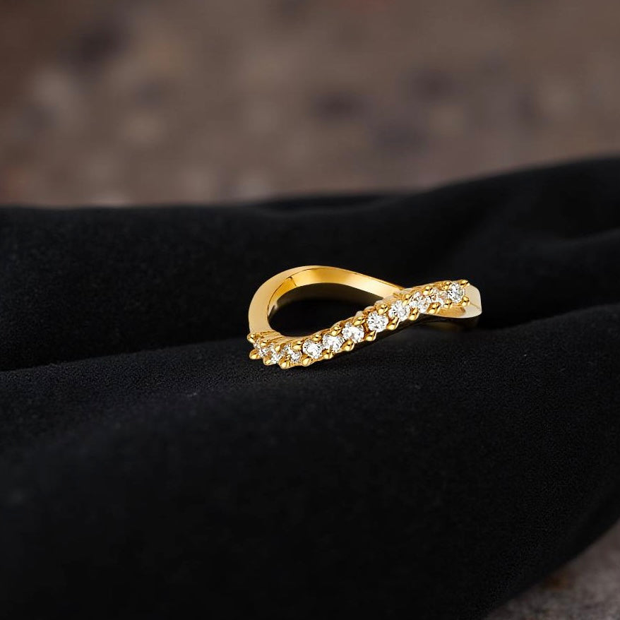 Dainty 14K gold bridal band placed gently on a black velvet cloth, emphasizing its delicate size and classic design.
