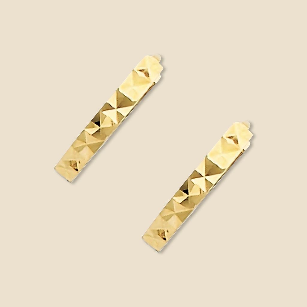 A pair of 14K yellow Gold Huggies earrings against a plain backdrop, clearly showing the 11mm round shape and diamond-cut design.