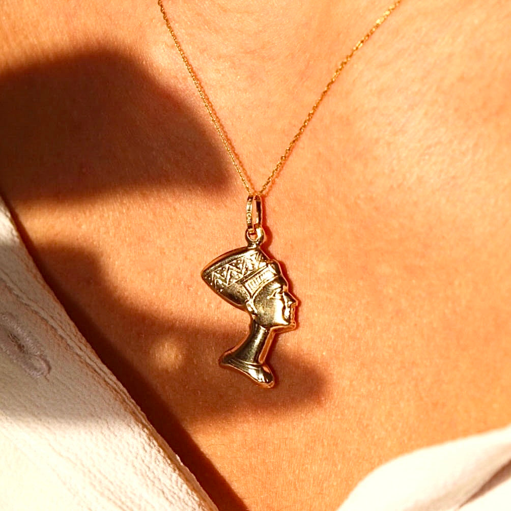 A model wearing the 14K Real Gold Nefertiti Charm on a delicate chain, highlighting the elegance and regal design of the pendant.