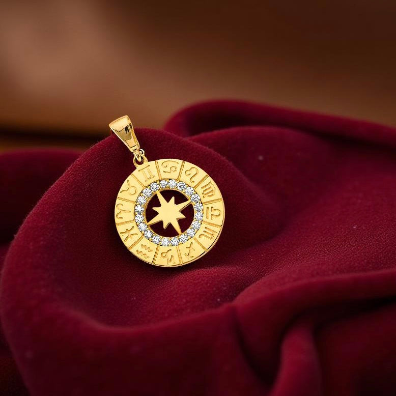 14K two-tone gold zodiac pendant resting on a dark red velvet cloth, displaying shimmering cubic zirconia accents.
