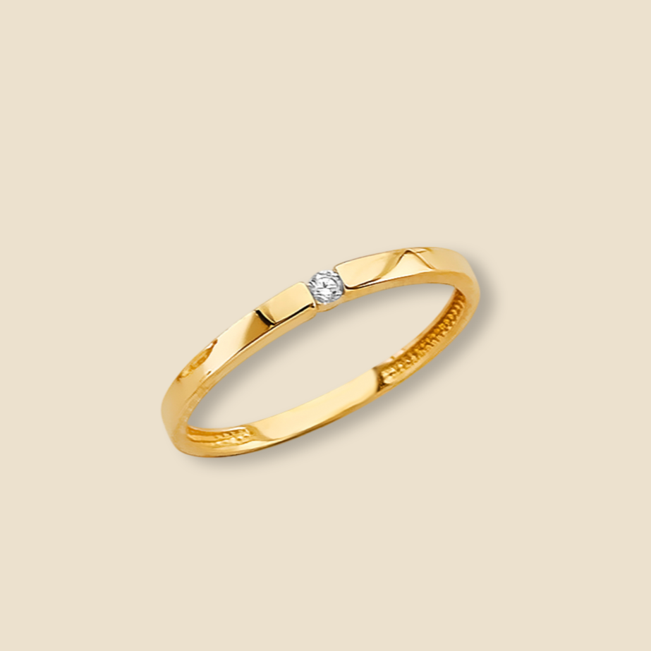 4K gold CZ ring photographed on a plain background, showcasing its sleek, minimalist silhouette and polished finish.