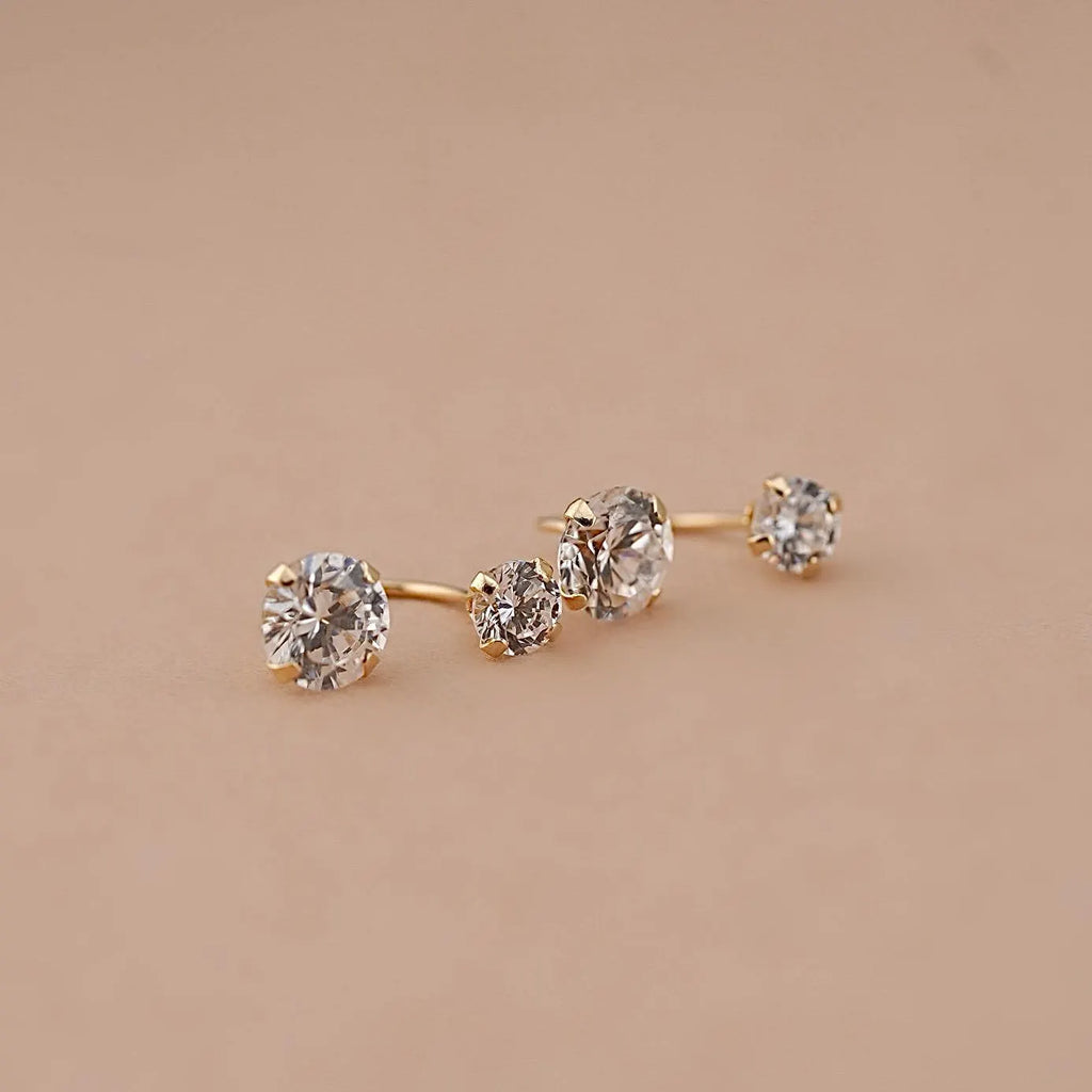 14K Solid Gold Telephonic Earrings with white zirconia stones, resting on a plain background to highlight their polished finish and secure screw-back design.