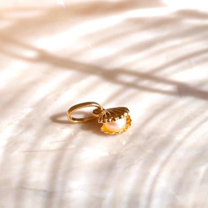 A close-up image of a 14K Solid Gold Pearl Pendant against a plain white background, showcasing its smooth, lustrous pearl set in polished yellow gold.